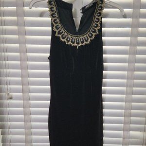 Black cocktail dress decorated with gold neckline